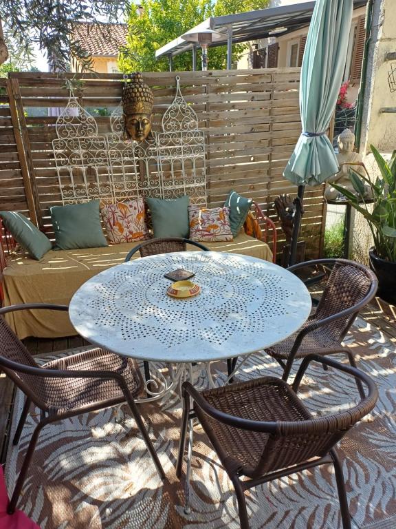 a blue table and chairs on a patio at Le toit du monde in Ceyreste