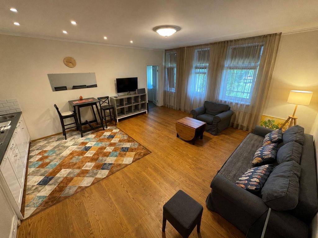 a living room with a couch and a table at Babite Quiet Apartment in Babīte