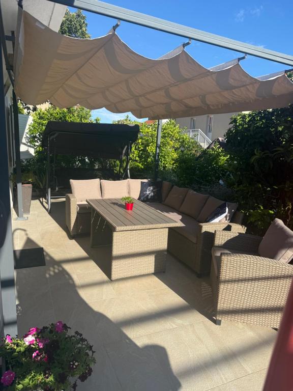 a patio with a couch and a table under an umbrella at Blue Sunset in Razvala