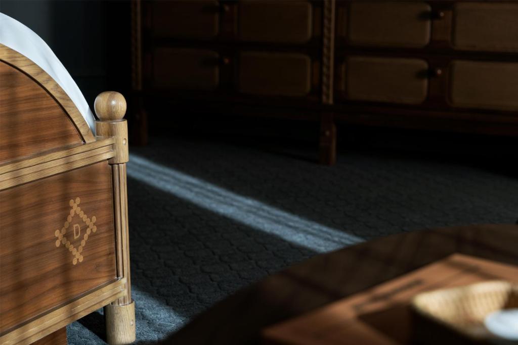a close up of a wooden bed in a room at The Driskill in Austin