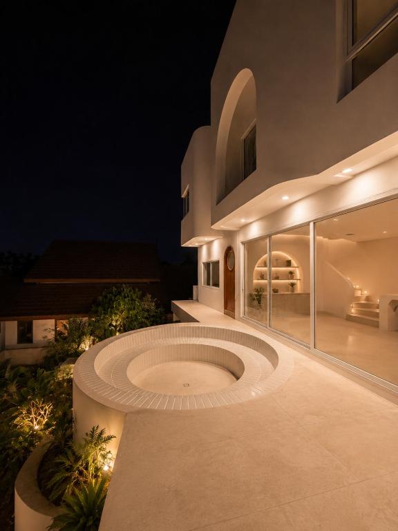 a night view of a building with a circular patio at CASA MARINe in Bophut