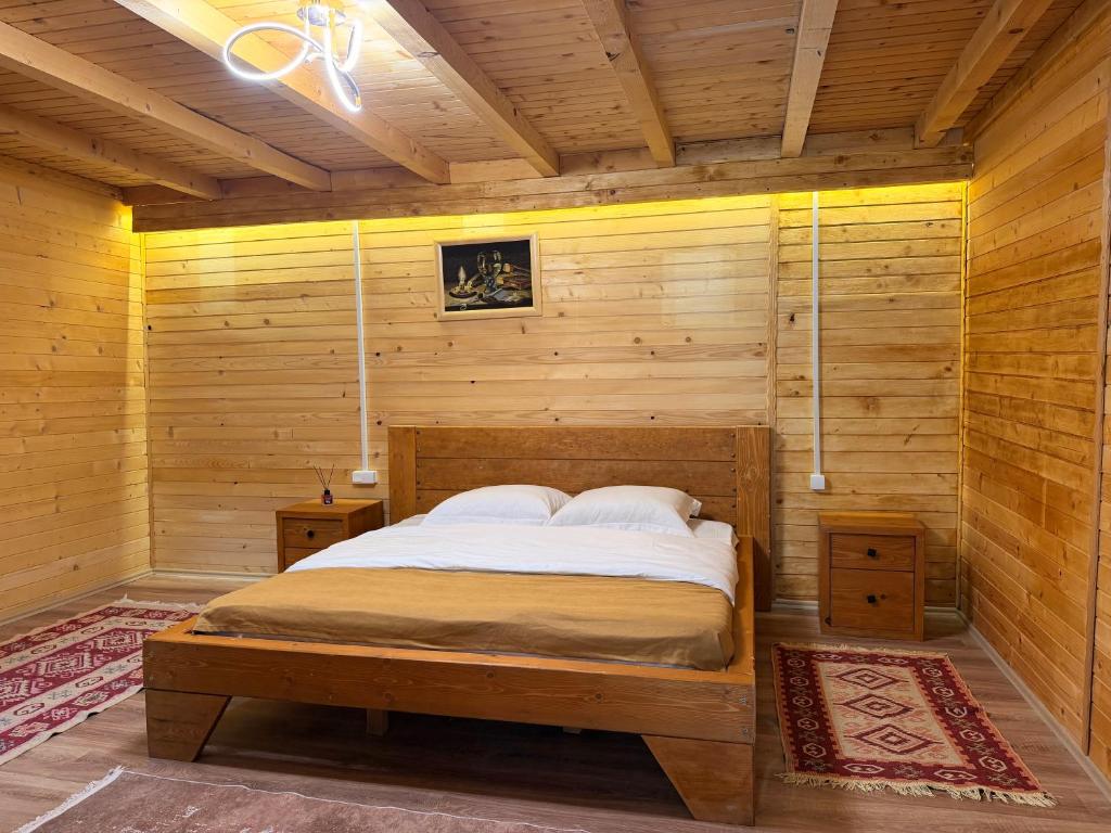 a bedroom with a bed in a wooden room at Valbone Two E in Valbonë