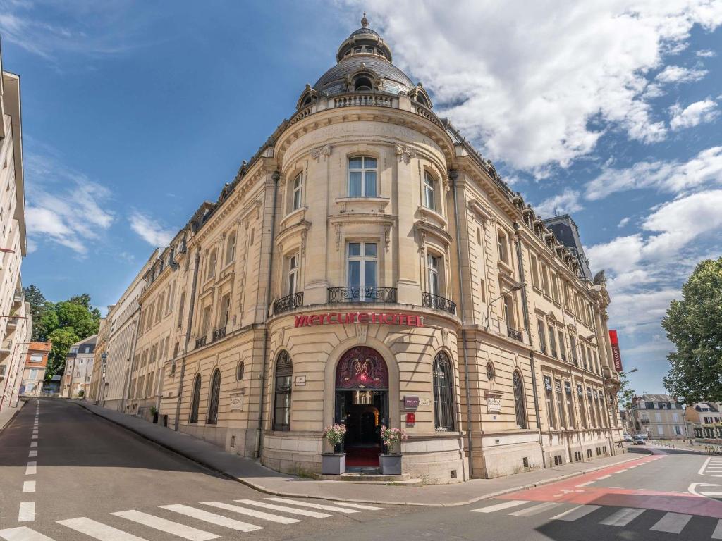 a large building on the corner of a street at Mercure Le Mans Centre in Le Mans