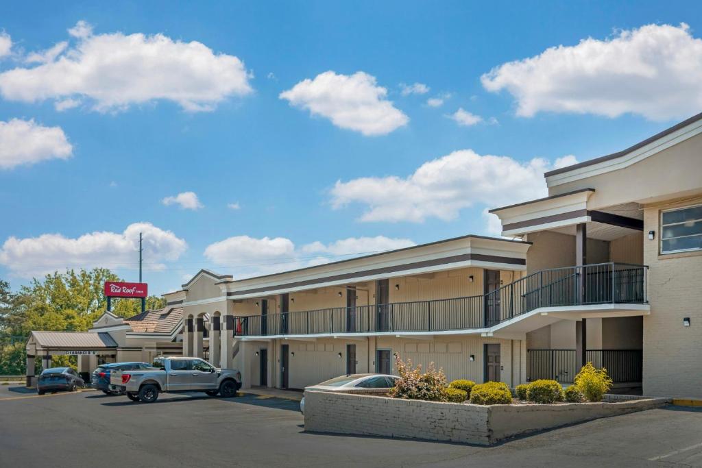 a hotel with cars parked in a parking lot at Red Roof Inn Gastonia in Gastonia