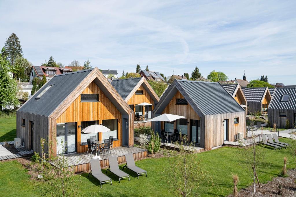 an image of a house with chairs and tables at Schmids Ferienoase in Ostrach