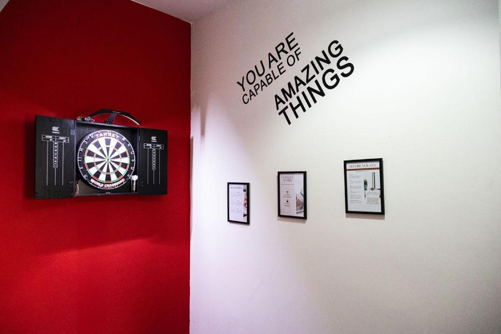 a wall with a dart board on a wall at Luton Grove in Liverpool