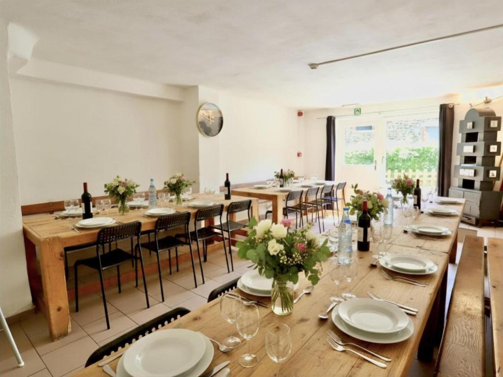 a large dining room with wooden tables and chairs at Le Noyer in Lierneux