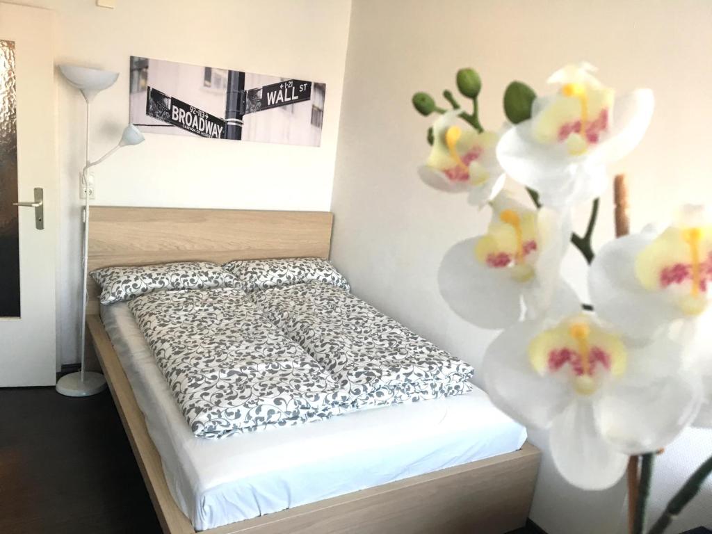 a bedroom with a bed with flowers on the wall at Business Appartement in Regensburg