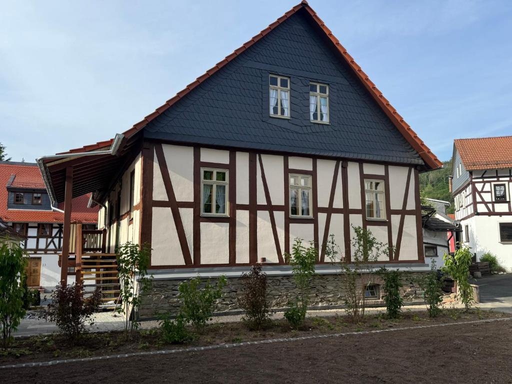 a half timbered house with a blue roof at Wohnen im Denkmal in Weilrod