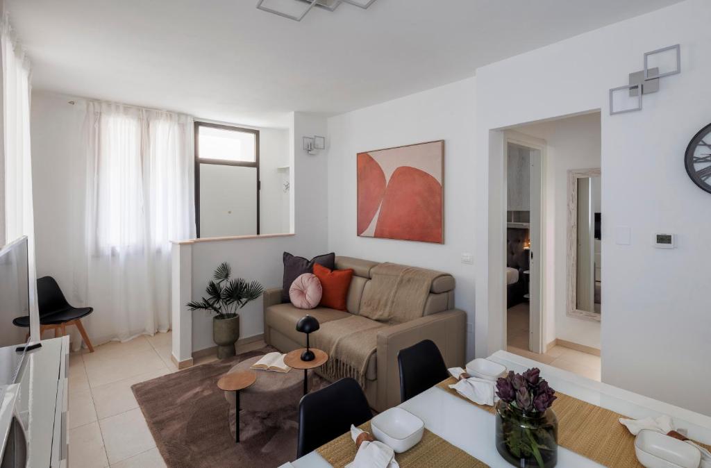 a living room with a couch and a table at Brezza della Fortuna in Fano