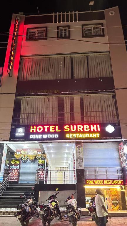 a hotel with motorcycles parked in front of a building at Hotel Surbhi in Shaikhpura
