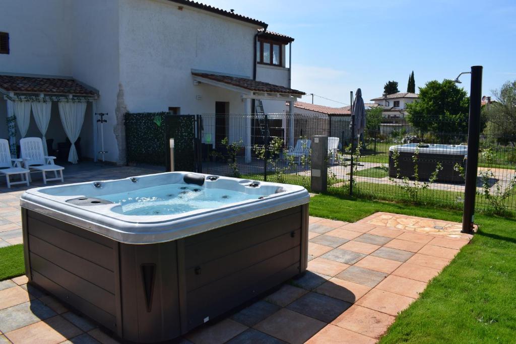 a hot tub in the backyard of a house at Apartments Casa Sossa in Vilanija