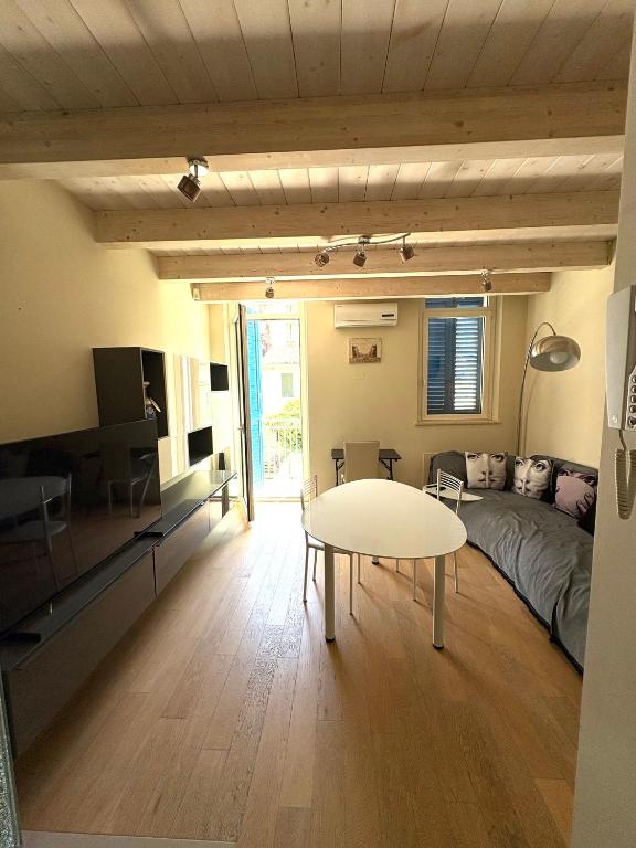 a living room with a table and a couch at Dimora Dell Olmo in Civitanova Marche