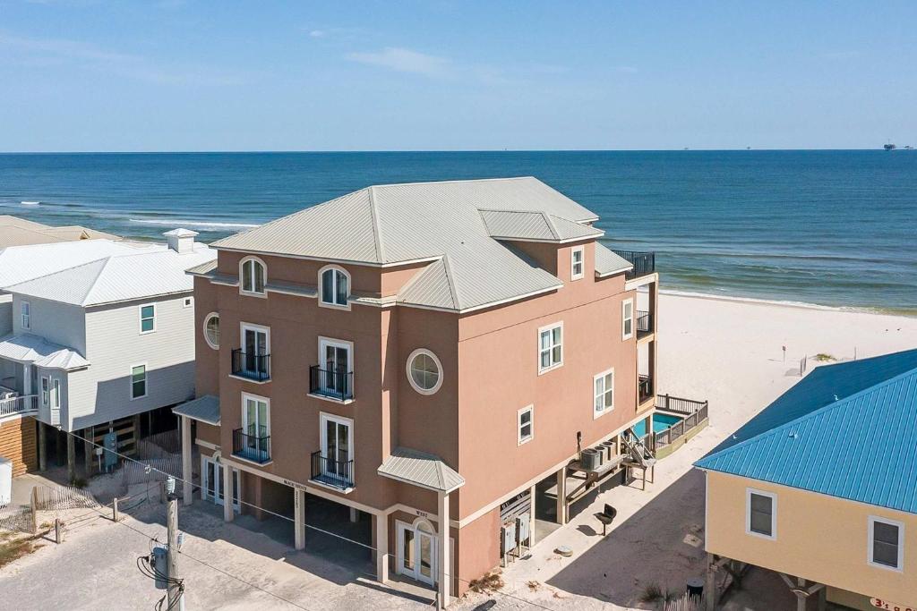 an aerial view of a building next to the beach at Luxury Beachfront Duplex in Fort Morgan - Pool Elevator and Wedding-Friendly in Gulf Shores