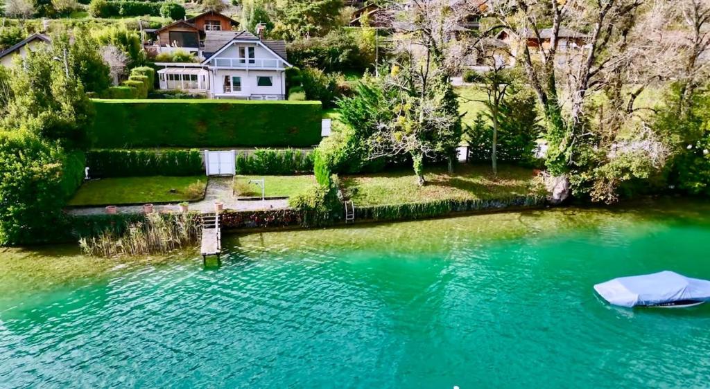 an aerial view of a house next to a lake at La Maison Du Lac in Doussard