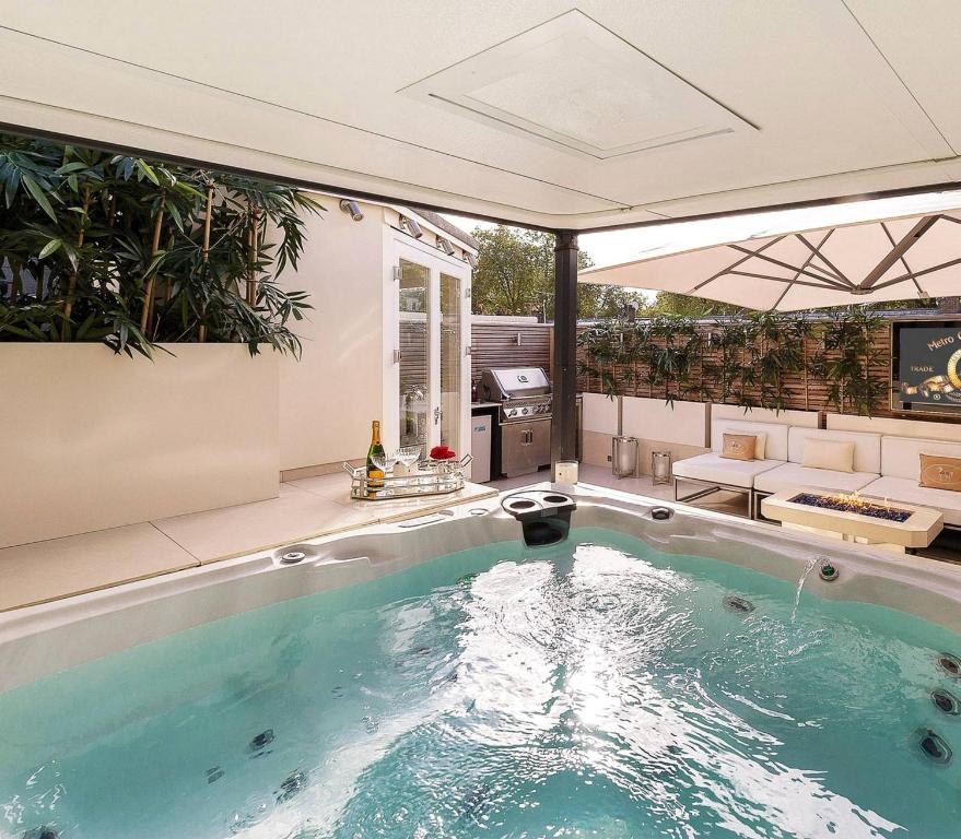 a hot tub in a room with a patio at MariaHilferHome in Vienna