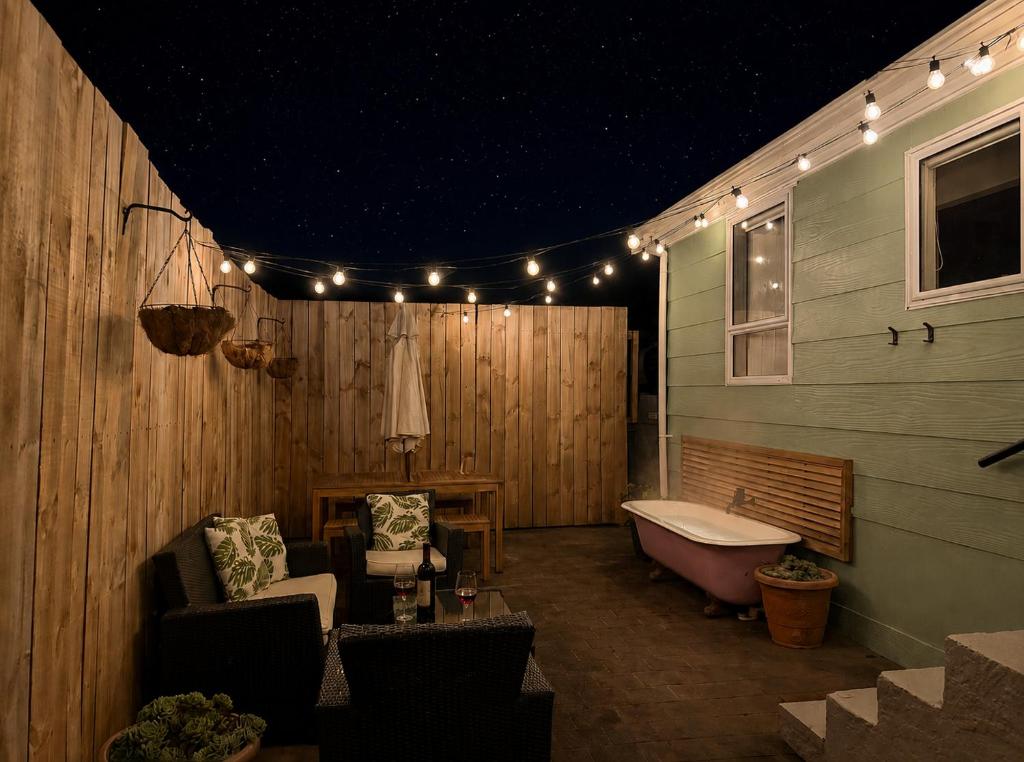 a bathroom with a tub and a bench and lights at Waikanae Beach Abode in Waikanae