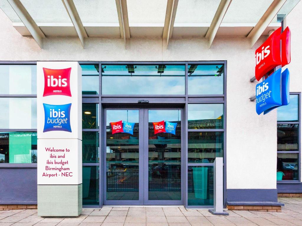 a store front with signs in front of it at ibis budget Birmingham Airport Terminal Building - NEC in Bickenhill
