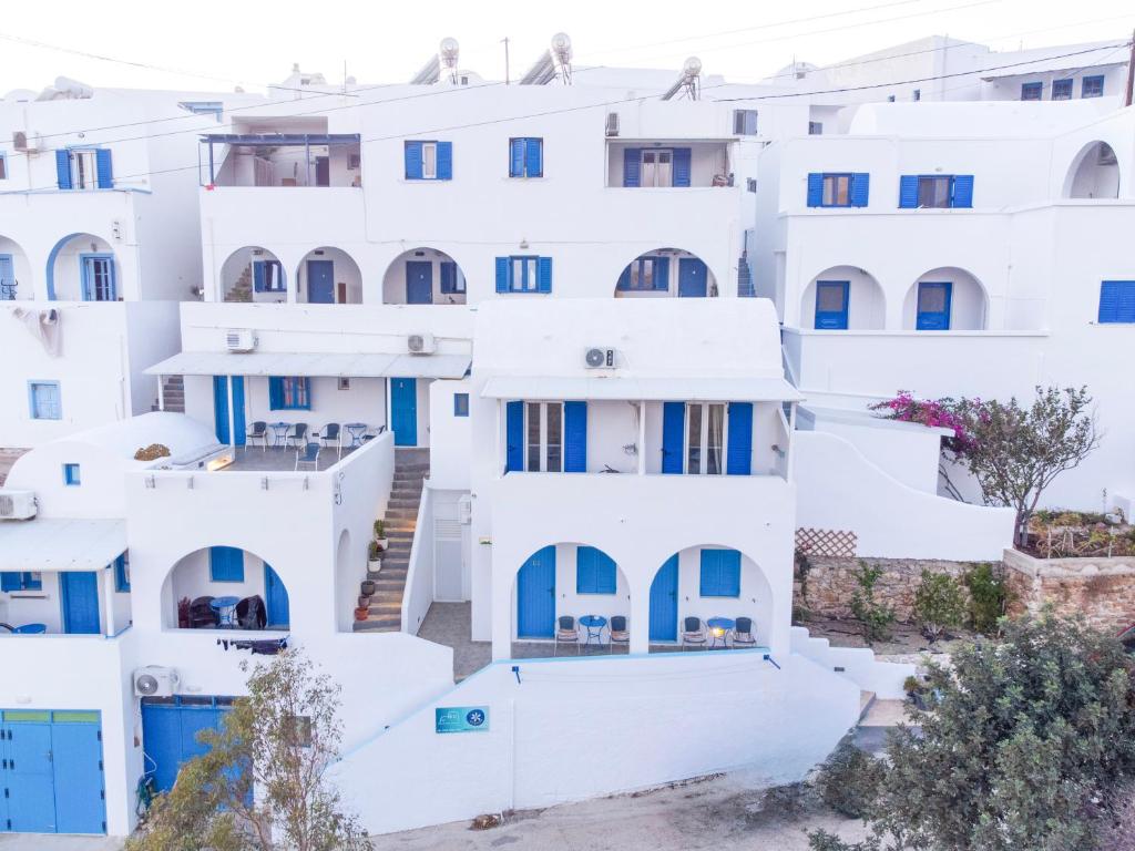 a cluster of white buildings with blue doors at Panorama Rooms in Anafi