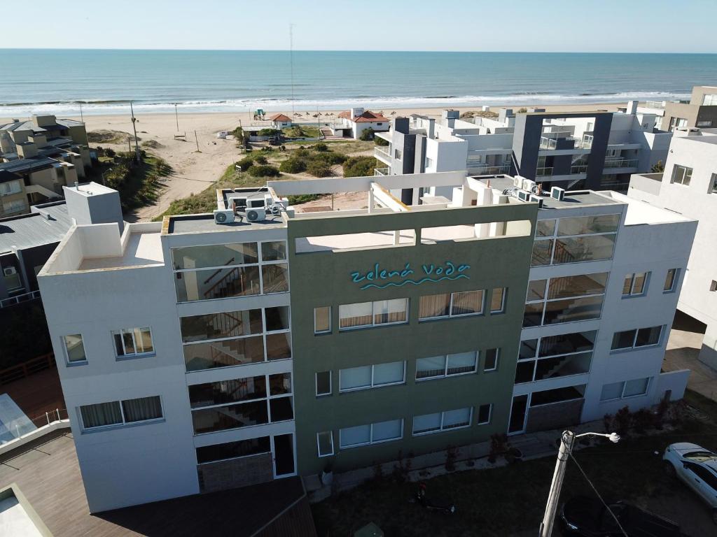 a view of a building and the beach at Zelena Voda in Villa Gesell