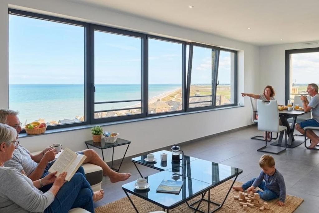 a group of people sitting in a living room with the ocean at AL 4 - Horizon Marin in Ault