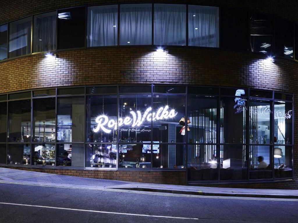 a store with a sign on the side of a building at Novotel Liverpool Centre in Liverpool