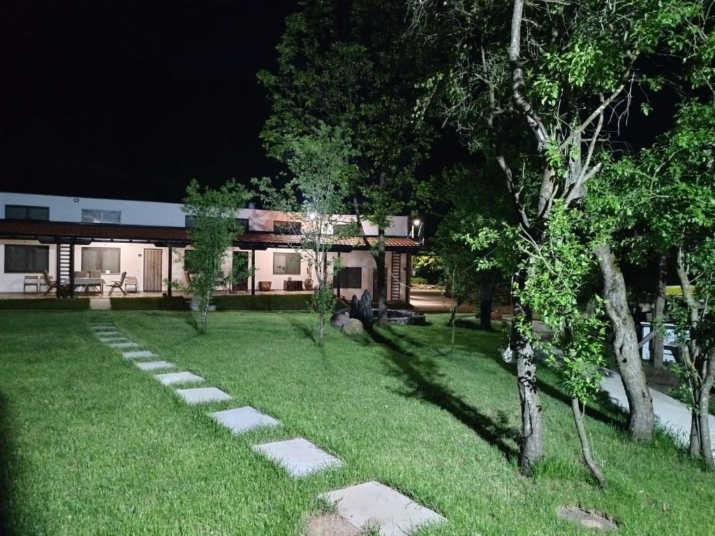 a garden at night with a house in the background at Apartman "Galerija" in Pirot