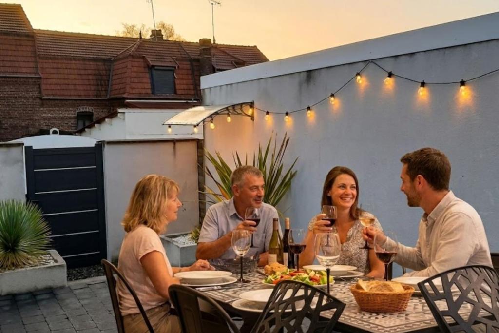 a group of people sitting around a table drinking wine at OF08 - Maison entre mer et forêt in Oust-Marais