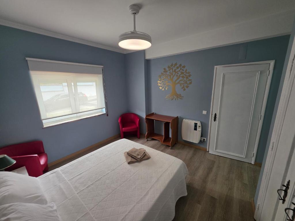 a bedroom with a bed and a table and a window at Quinta da Mainça in Coimbra