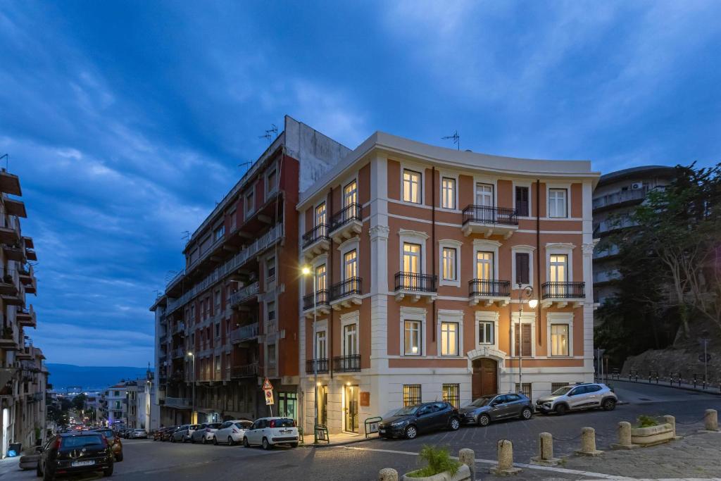 a tall building with cars parked in front of it at Best Western Plus Fontana Falconieri Hotel in Messina