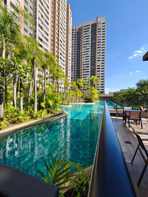 a swimming pool in a resort with tall buildings at Piscine Statio Resort Brás in São Paulo