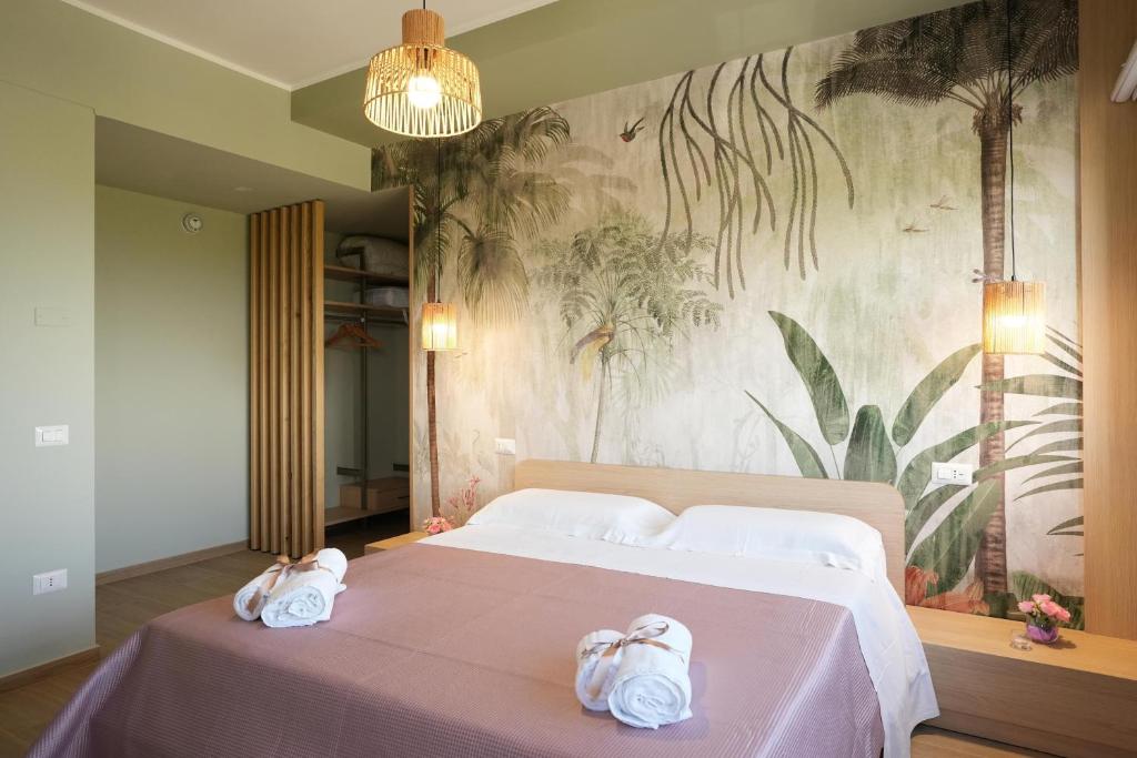 a bedroom with a large bed with towels on it at La Terrazza del benessere in Ferrazzano