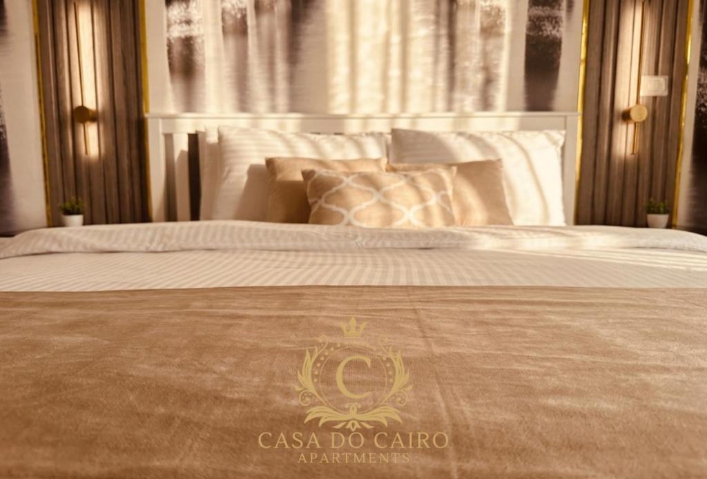 a bed with a casonico do calico logo on it at Casa Do Cairo - Rehab City in Cairo