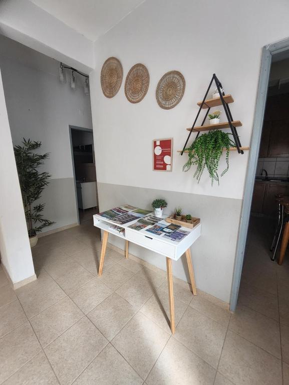 a white table in a room with plates on the wall at A Romãzeira in Torre de Moncorvo