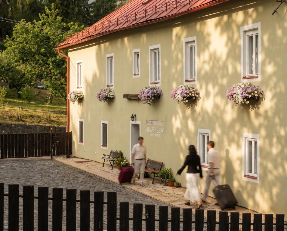 a group of people walking in front of a building at Frauenberg Villa in Banská Štiavnica