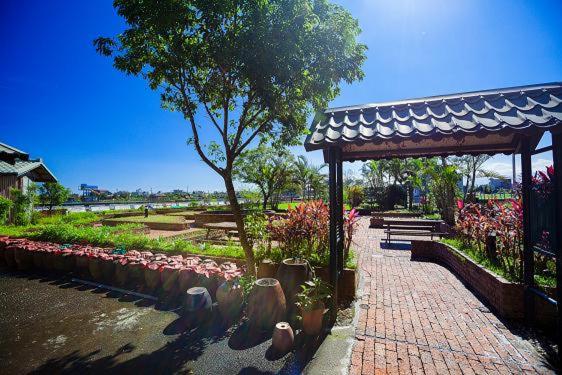 a park with a pavilion and a walkway with plants at Chun Feng Cao Tang Homestay in Yuanshan