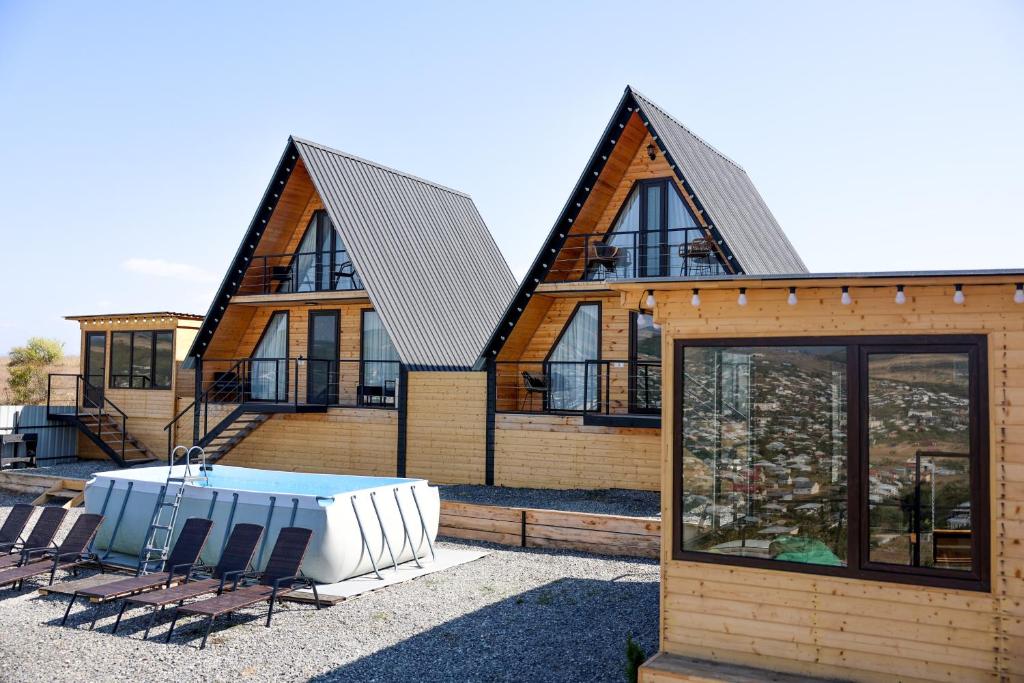 a house with a pool in front of it at Gemini Cottage in Dusheti in Dushetʼi