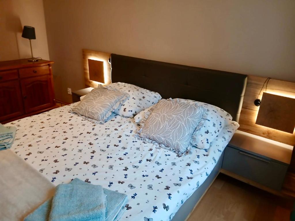 a bed with two pillows on it in a bedroom at Apartament Na Wydmie - parter in Ustka