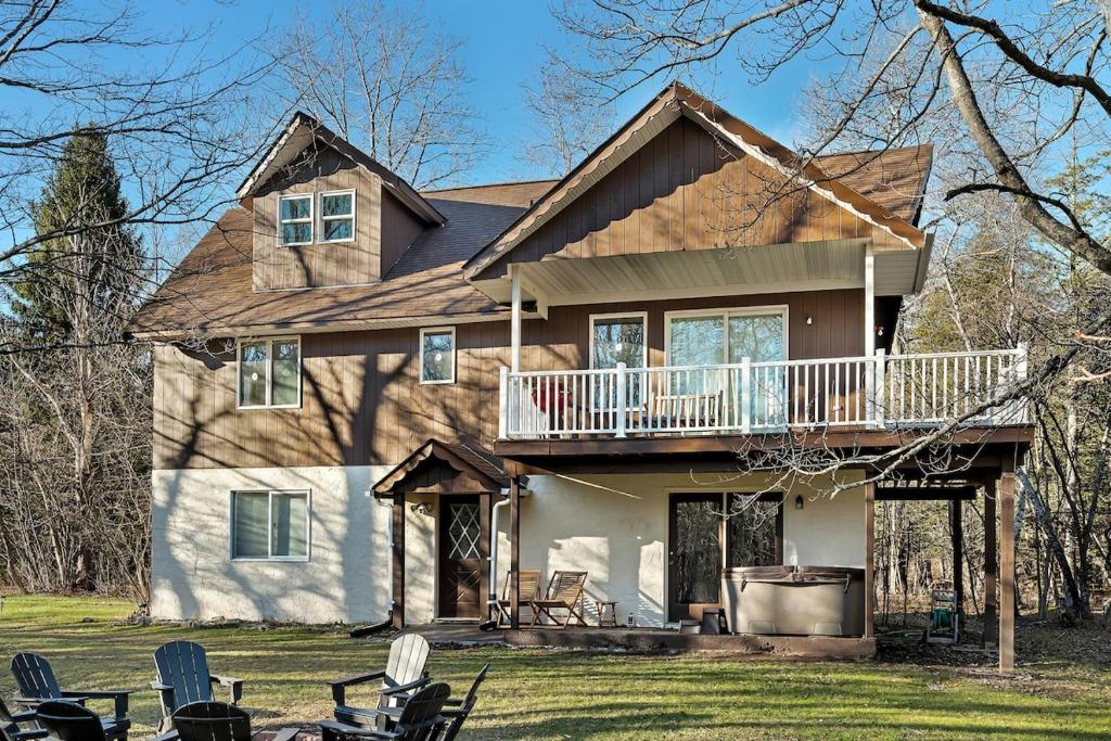 a large house with a porch and a deck at Luxury Mountain Villa - 3 bedroom, hot-tub, fire-pit in Hunter