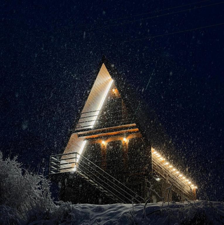 a building in the snow at night at Sno Valley Cottage in Sno