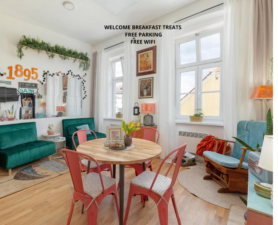 a living room with a table and chairs at Casa 1895 , Boutique Stay in a Historic Townhouse near the Beer Fountain in Žalec