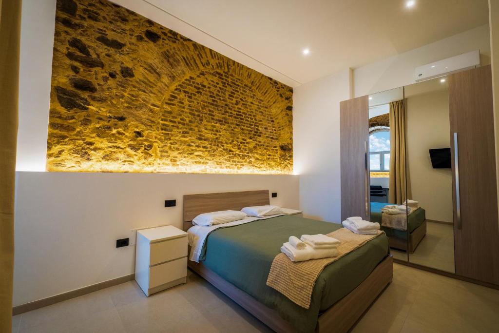 a bedroom with a bed and a painting on the wall at B&B Hipponion in Vibo Valentia