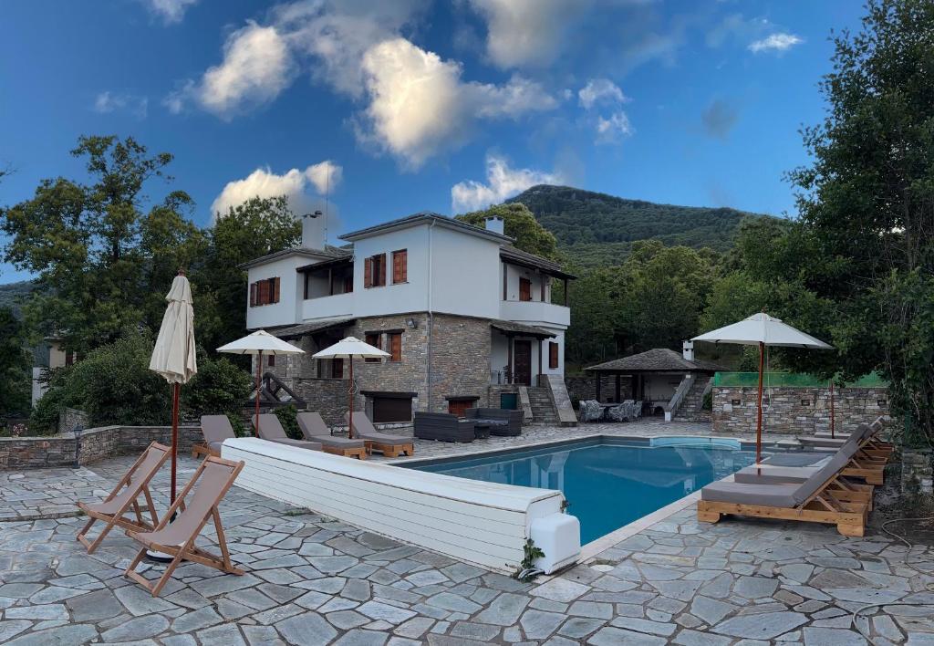 a villa with a swimming pool and a house at Villa Maria Amalia in Tsagarada