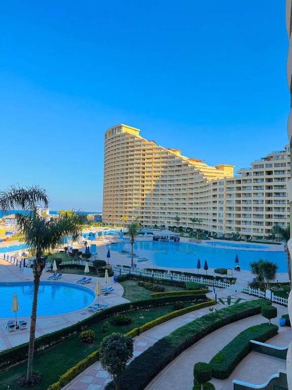 a resort with two pools and a large building at Porto sokhna pyramids in Ain Sokhna