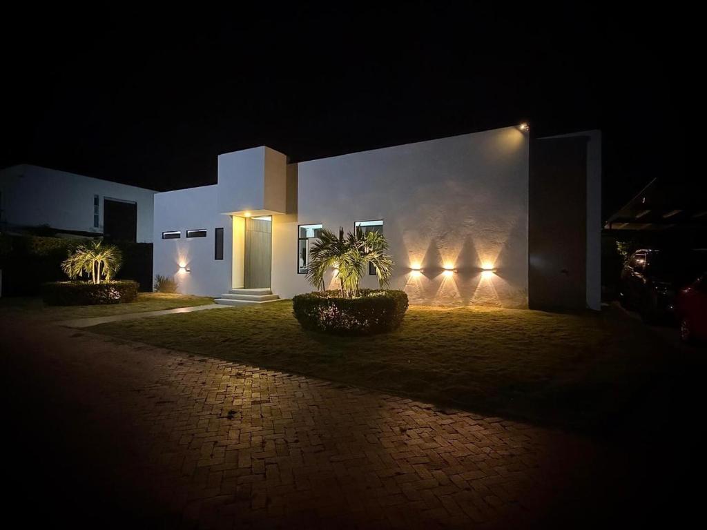 a building with lights on the side of it at night at Casa Aqua in Nilo