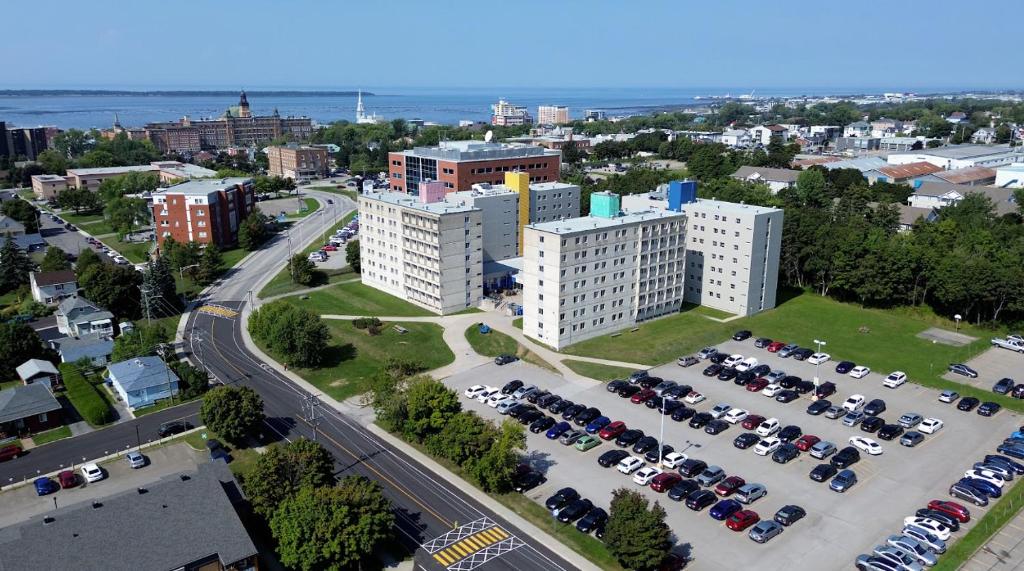 an aerial view of a city with a parking lot at Résidences du Cégep de Rimouski in Rimouski