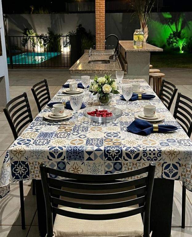 a table with a blue and white table cloth on it at Espaço Manacá in Dourados