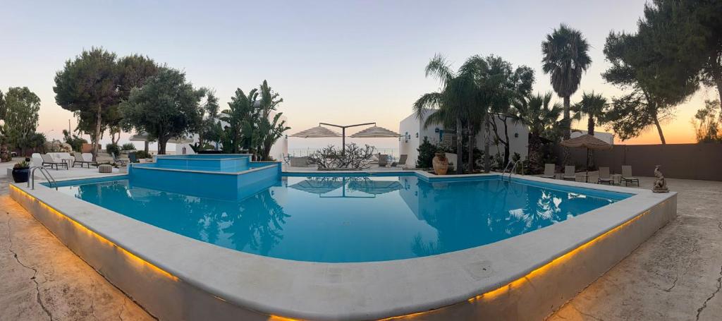 a large swimming pool with blue water at Villa Mare Di Montelusa in Agrigento