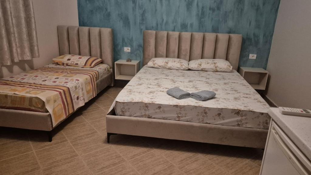 a bedroom with two beds in a room at Amras house in Durrës
