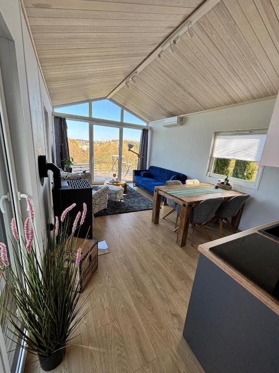 a living room with a table and a couch at Weitblick- Sauna- WLAN- Haus 3 in Neheim-Hüsten